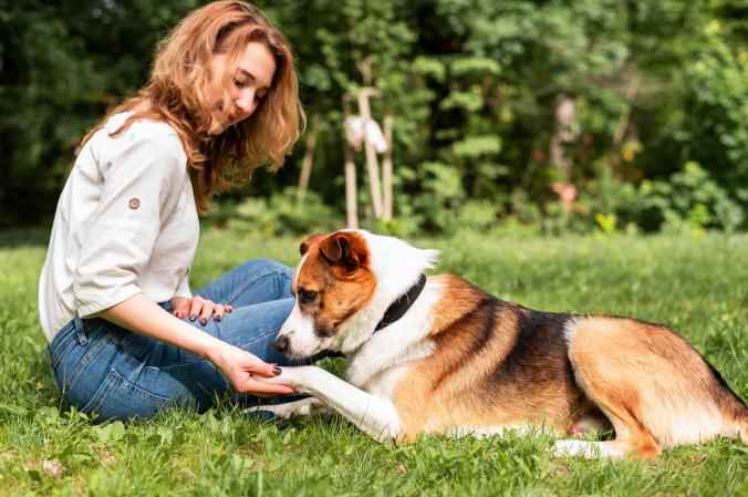 woman playing with her dog in the park